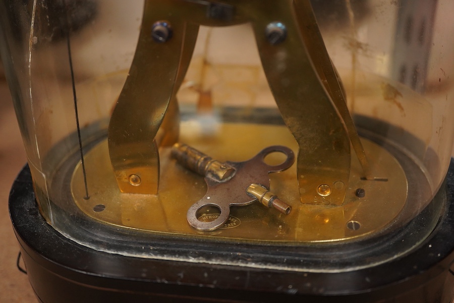 19th century French repeating brass mantel timepiece under glass dome, 26cm high.